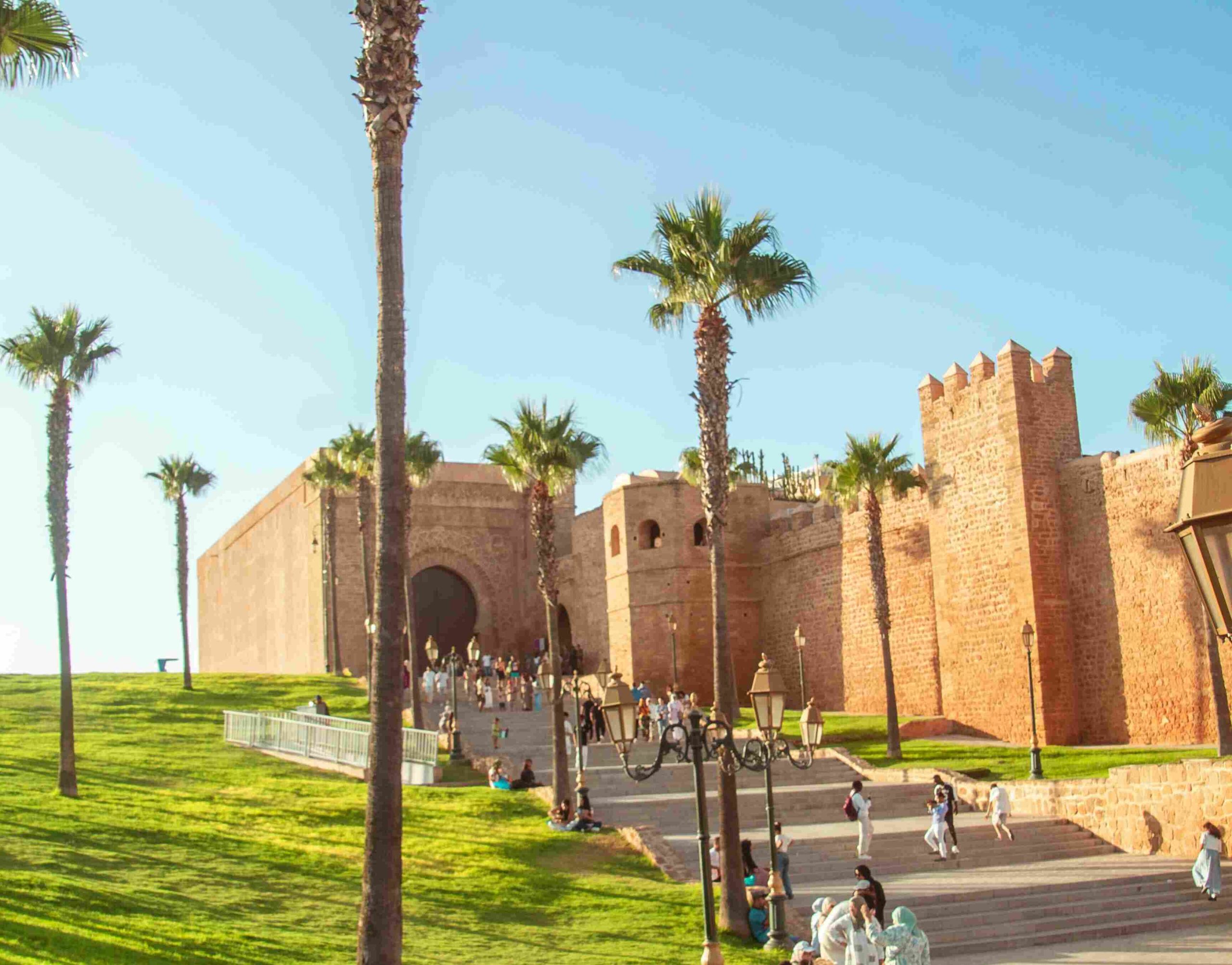 Crowds of people walking through Jemaa el-Fnaa square in Marrakech, Morocco surrounded by market stalls and traditional architecture